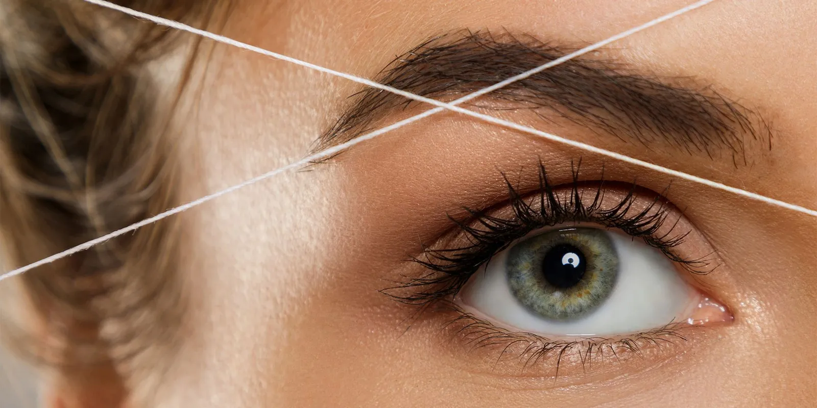 Close-up of eyebrow threading