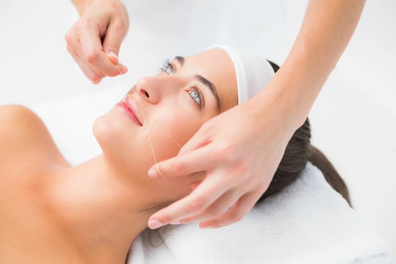 Upper-lip threading with a cotton thread
